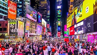 crowd of people walking through times square in NYC, New York, USA