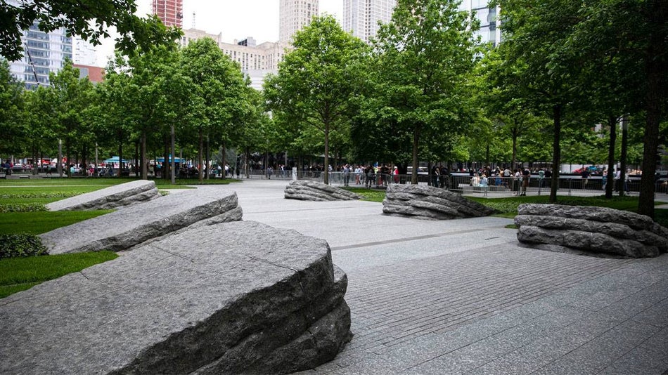 Wide shot of the Memorial Glade, a concrete walk way surrounded by trees in NYC, New York, USA