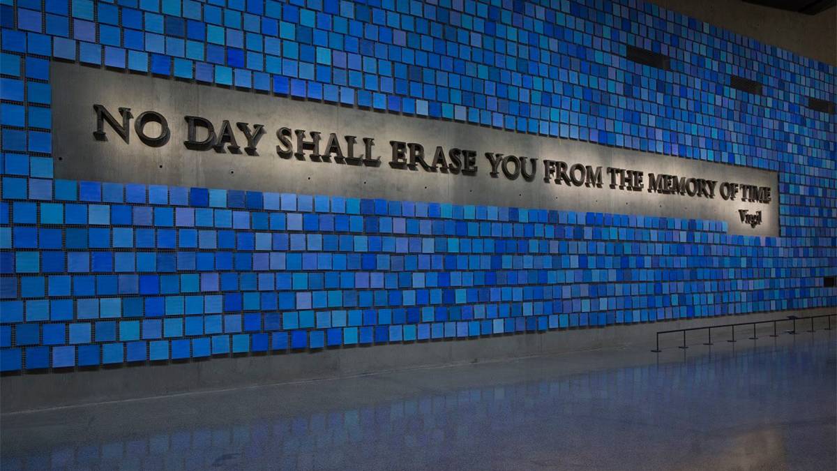 Close up of Trying to Remember the Color of the Sky on That Tuesday Morning, a 9/11 Art Memorial made of concrete and blue tiles with the words "NO DAY SHALL ERASE YOU FROM THE MEMORY OF TIME" in an all caps service font with lights at the National September 11 Memorial & Museum in NYC, New York, USA
