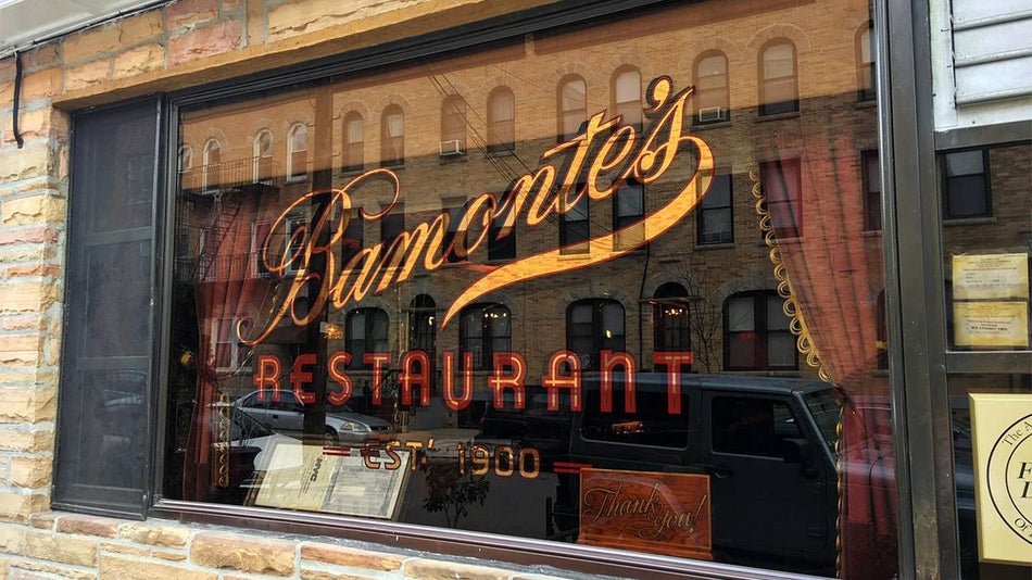 Window at Bamonte’s Restaurant with their logo on it in NYC, New York, USA