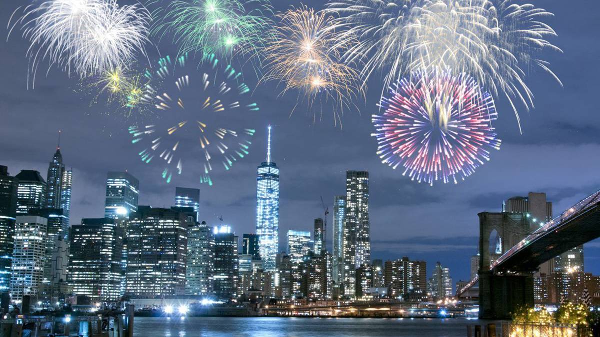 fireworks over Hudson River with Brooklyn Bridge and skyline in NYC, New York, USA