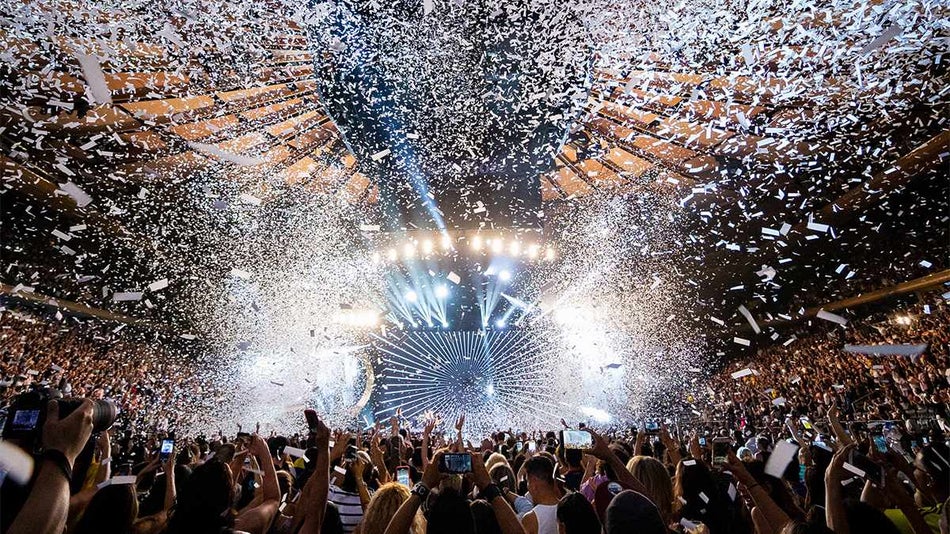 Wide shot of a concert with confetti falling down at Madison Square Garden in NYC, New York, USA