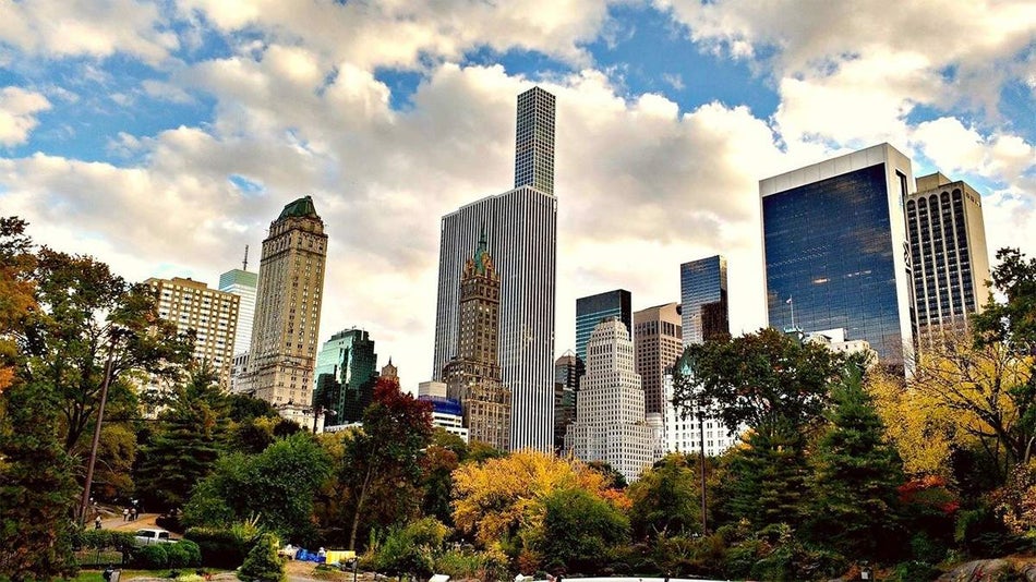 view of skyline and autumn trees in Manhattan from Central Park in NYC, New York, USA