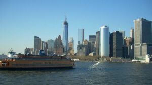 close up of Staten Island Ferry in harbor during daytime with skyline in the background in NYC, New York, USA