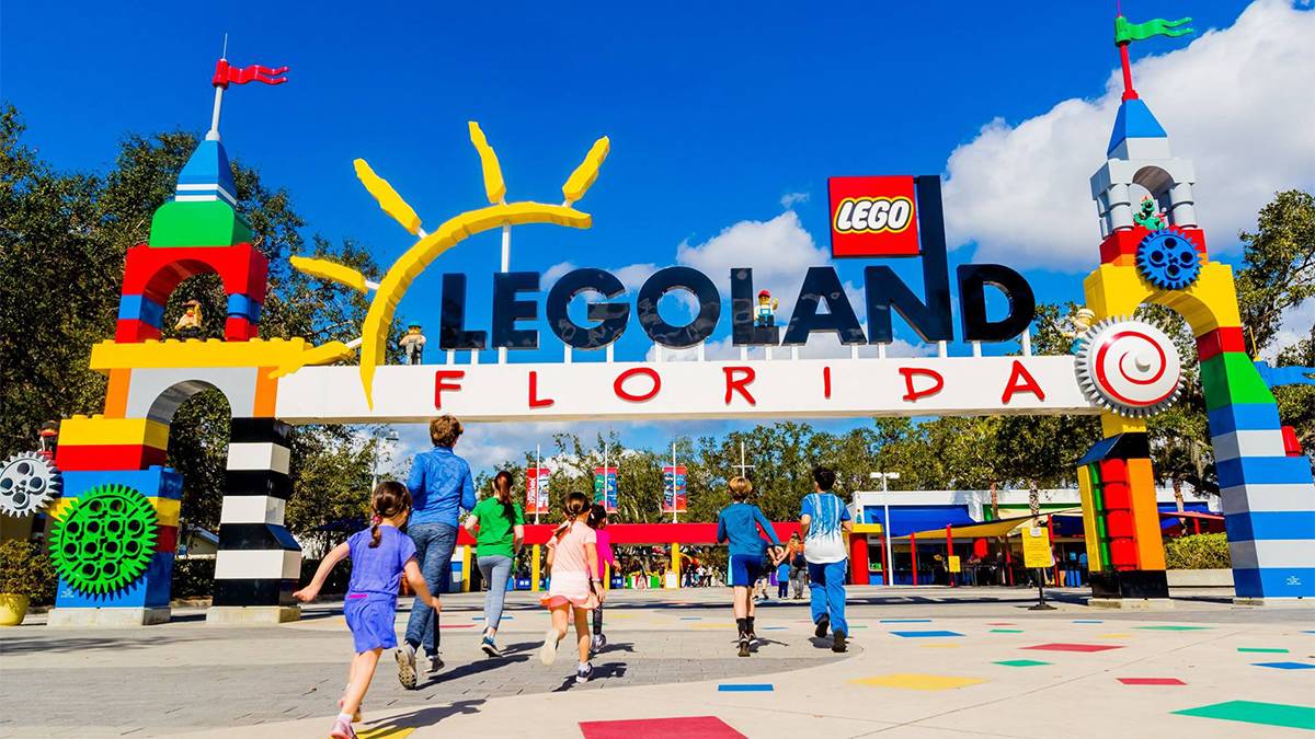 Children running into LEGOLAND Florida is the entrance sign over head on a sunny day in Orlando, Florida, USA