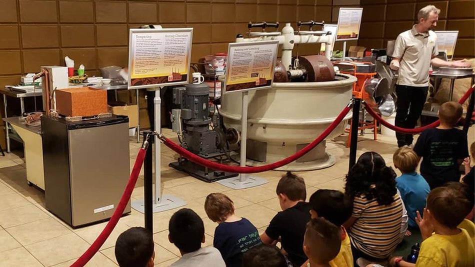 Close up of a group of preschoolers sitting watching the Chocolate Kingdom Factory Tour presentation in Orlando, Florida, USA