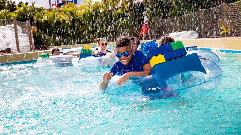 Close up of children in clear LEGO tubes on the lazy river at LEGOLAND Waterpark in Orlando, Florida, USA