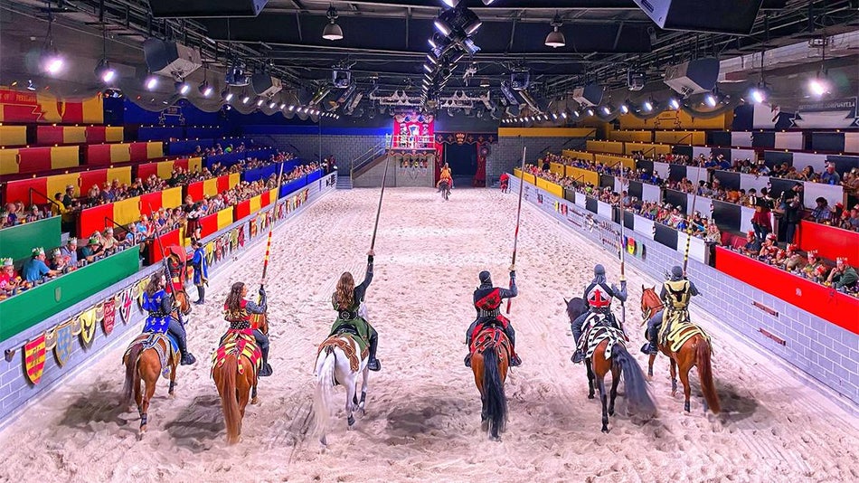 line of horses and knights with jousting poles at the Medieval Times dinner show in Orlando, Florida, USA