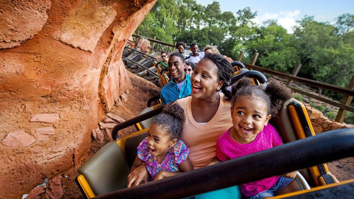 mom with two daughters on roller coaster at walt disney world in orlando florida