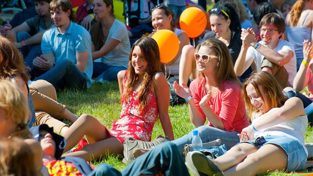 People Sitting on the Lawn at an outdoor Event/Concert