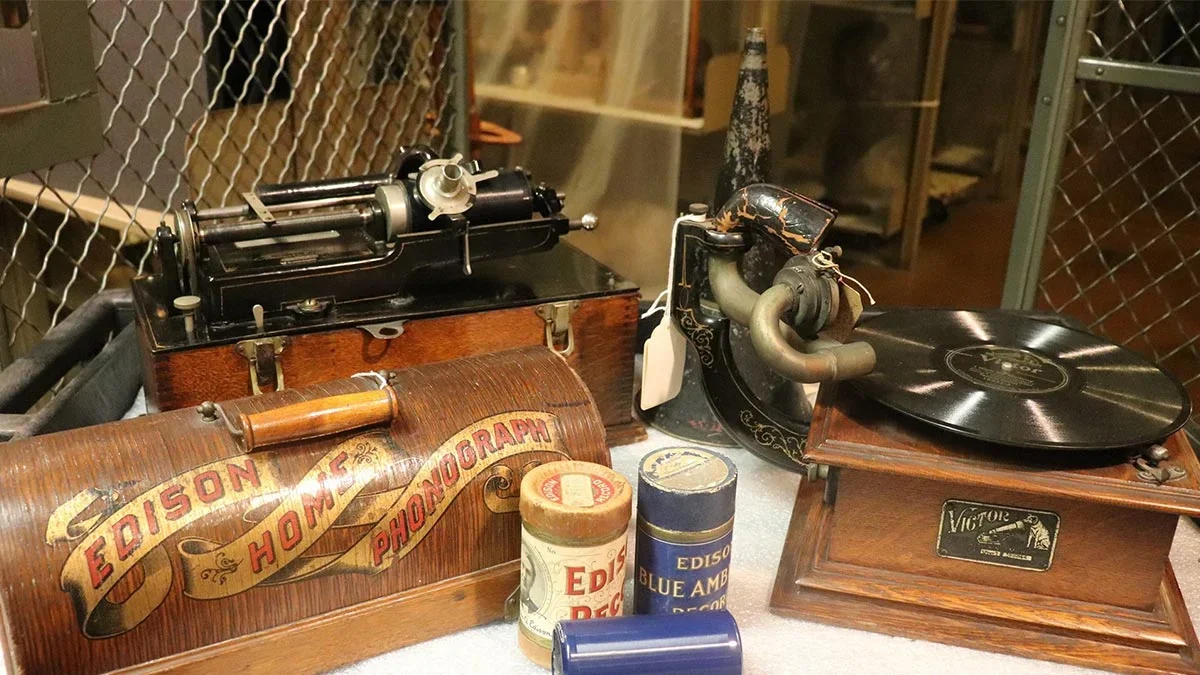 Close shot of an old record player and an Edison Home Phonograph with a few Edison Cylinders sitting next to it at the Franklin Institute Science Museum in Philadelphia, Pennsylvania