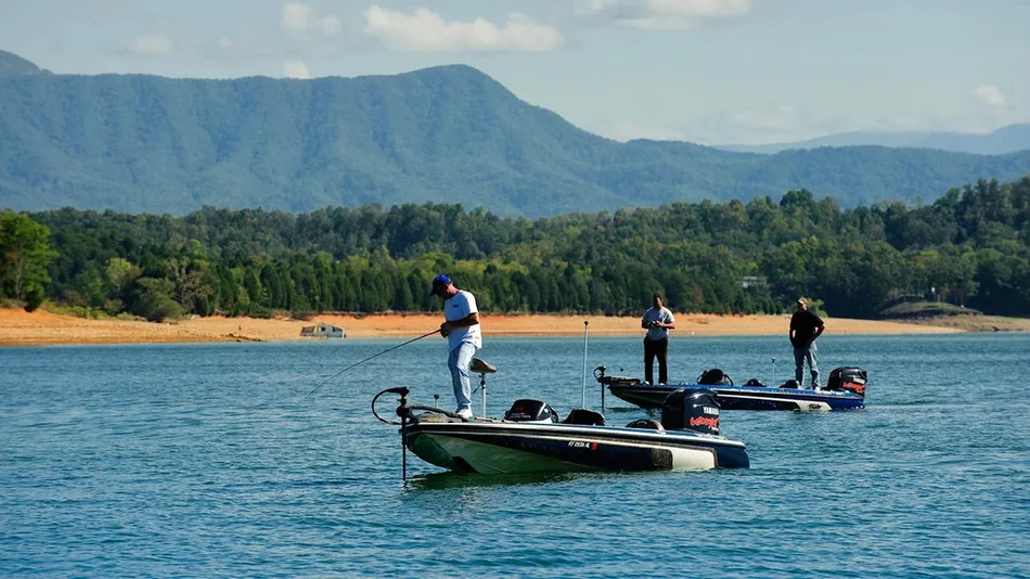 three men on fishing boats on a sunny day in Douglas Lake in Pigeon Forge, Tennessee, USA