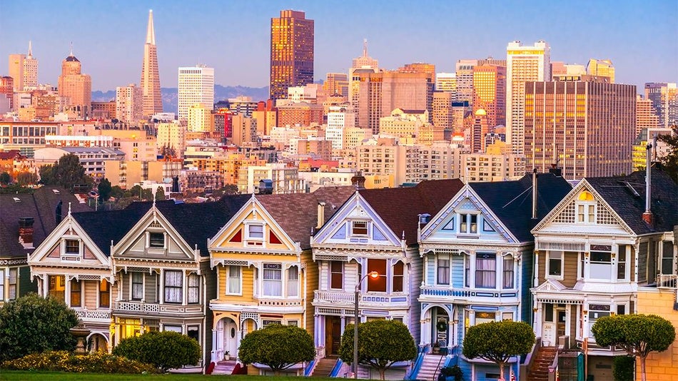 View looking down at the Painted ladies at sunset with the city behind them in San Francisco, California, USA