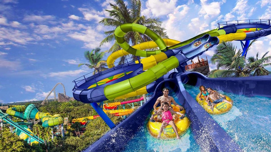 Close up photo of a family going down a waterslide on yellow tubes at Adventure Island in Tampa, Florida, USA