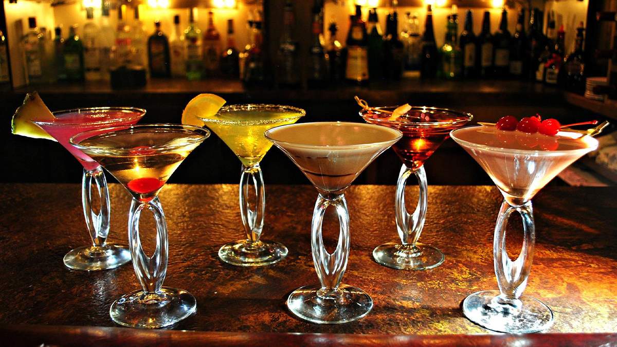 Close up photo of six different martinis on a dark brown counter at Aberdeen Barn in Williamsburg, Virginia, USA