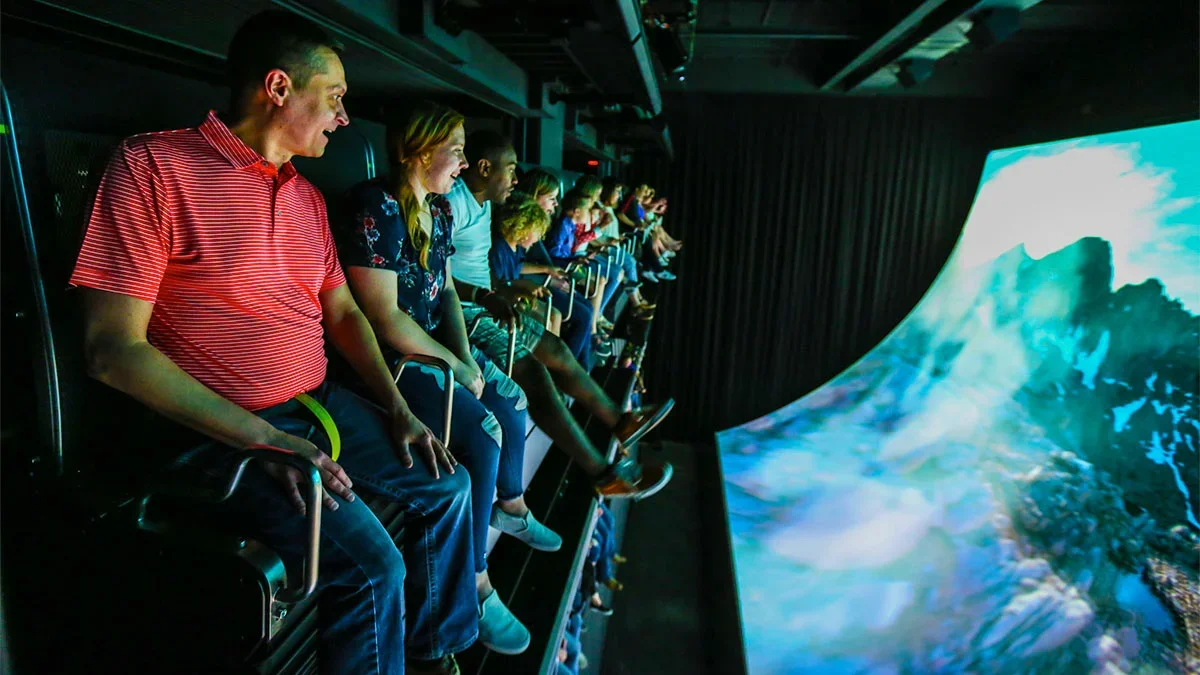 people seated on FlyRide adventure ride while viewing large screen at Beyond the lens Branson in Branson, Missouri, USA