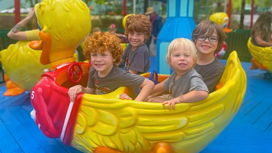 kids aboard yellow duck shaped ride on blue platform at Dollywood