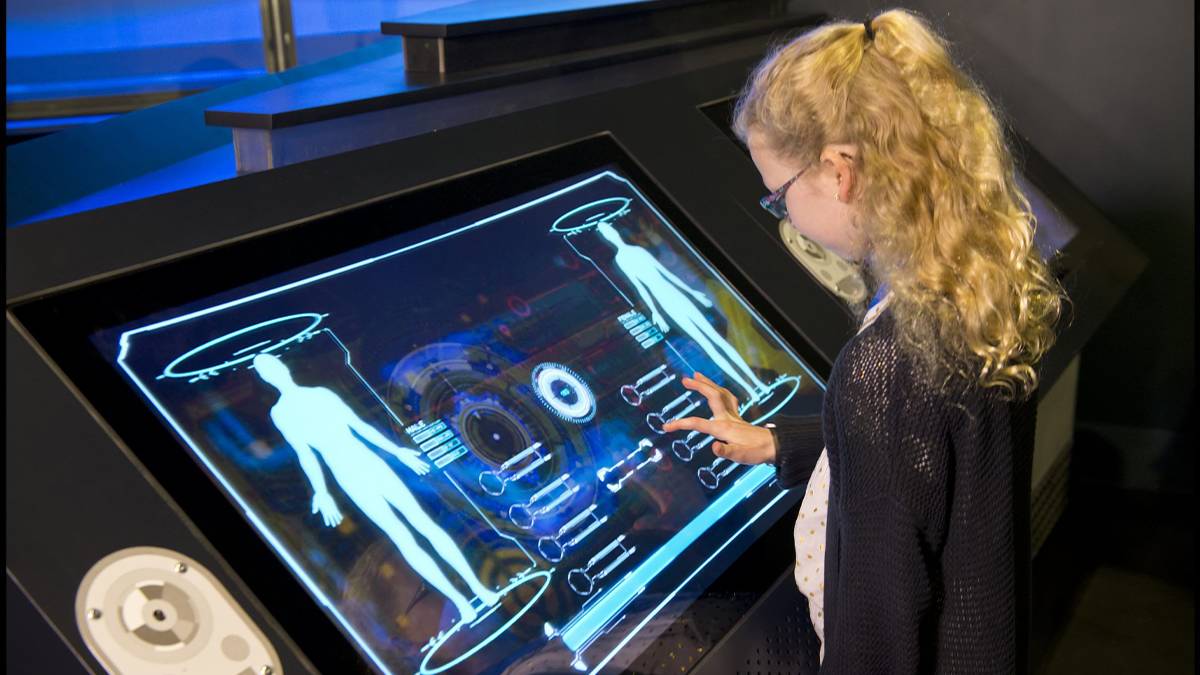 girl playing with interactive computer at kennedy space center