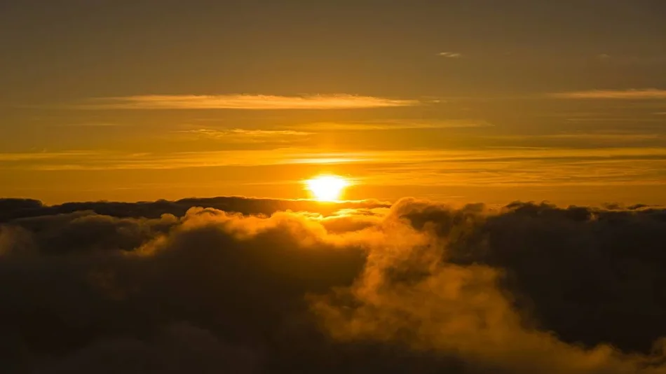 aerial view of bright orange sun over clouds at Haleakalā National Park in Maui, Hawaii, USA