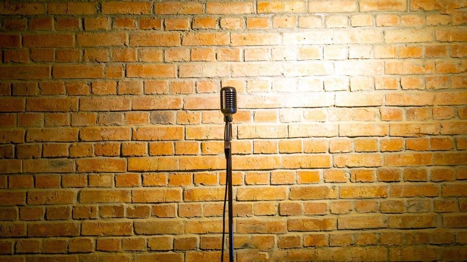 Stand up microphone on a stage with brick background