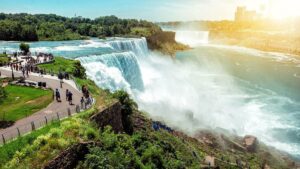 American side of Niagara falls, NY, USA. Tourists enjoying beautiful view to Niagara Falls during hot sunny summer day.