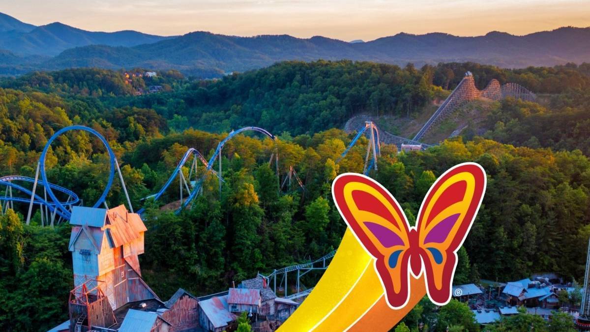 Butterfly logo on top of panromaic view of Dollywood park including a rollercoaster and trees.