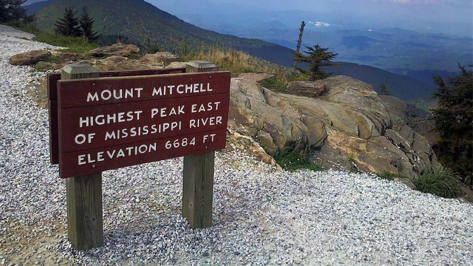 highest peak east of mississippi river sign at Mount Mitchell State Park with view overlooking the valley near Asheville, North Carolina, USA
