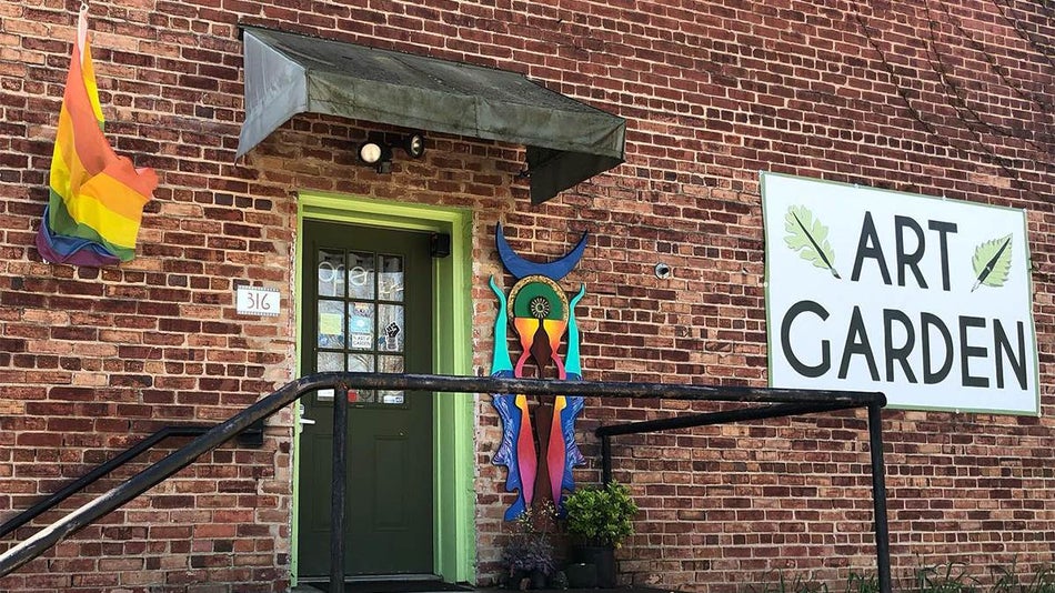 Photo of the door to the Art Garden with a sculpture to the right of it at the River Arts District in Asheville, North Carolina, USA