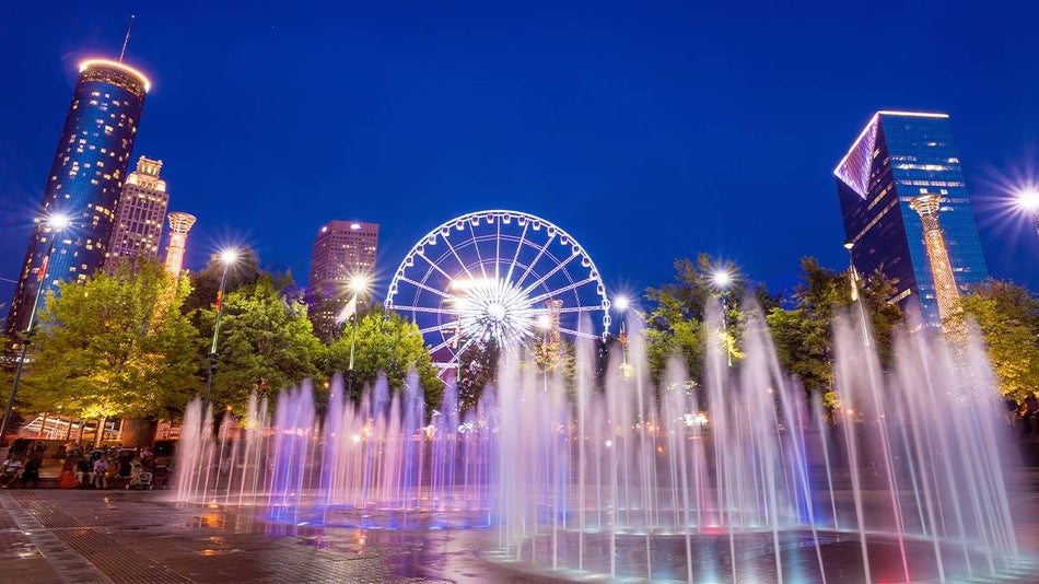 fountains with lights and ferris wheel in the background at twilight dust at Centennial Olympic Park in Atlanta, Georgia, USA