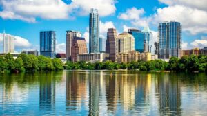 reflection of austin skyline in water with clouds and blue skies