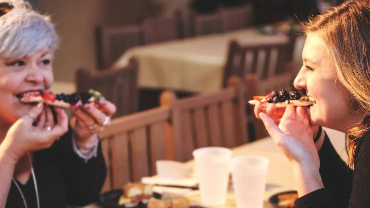 two women eating pizza at silver dollar city