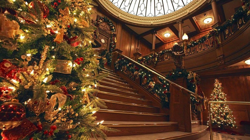 the grand staircase in the Titanic museum decorated with christmas garland lights and trees in Branson, Missouri, USA