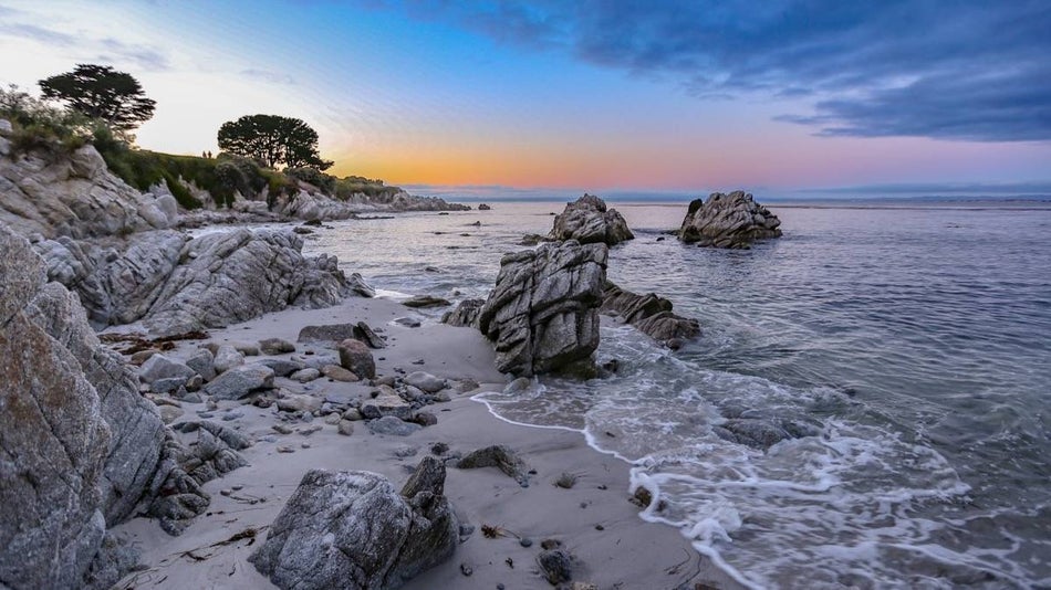 sandy and rocky coastline at Carmel, California at sunset.