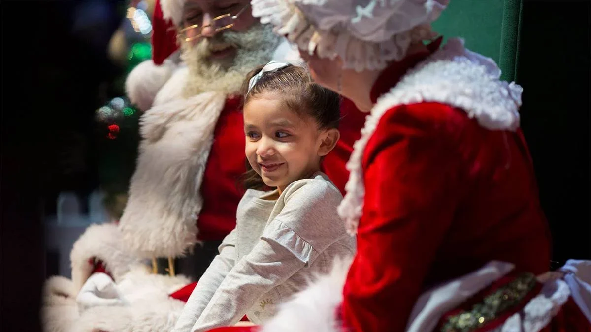 A child with Santa and Mrs Claus at the Winter Wonderfest in Chicago, IL, USA