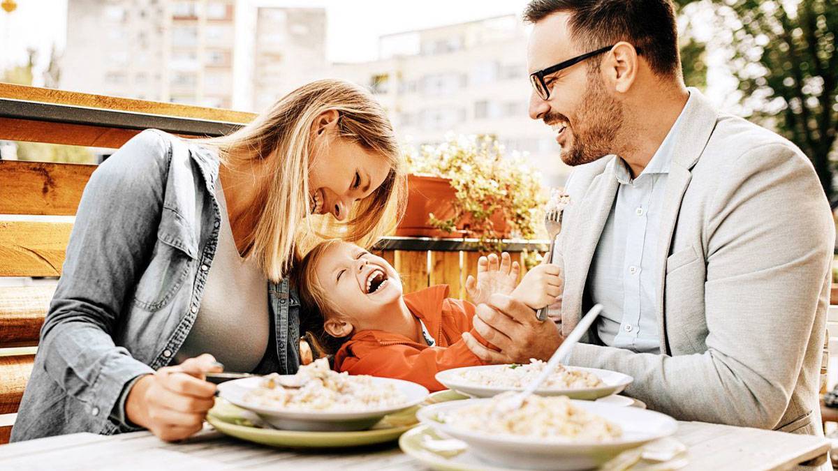 family laughing and eating together