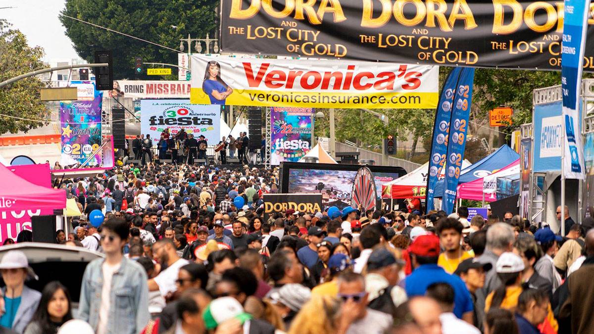 People walking around Fiesta Broadway in Los Angeles, CA, USA