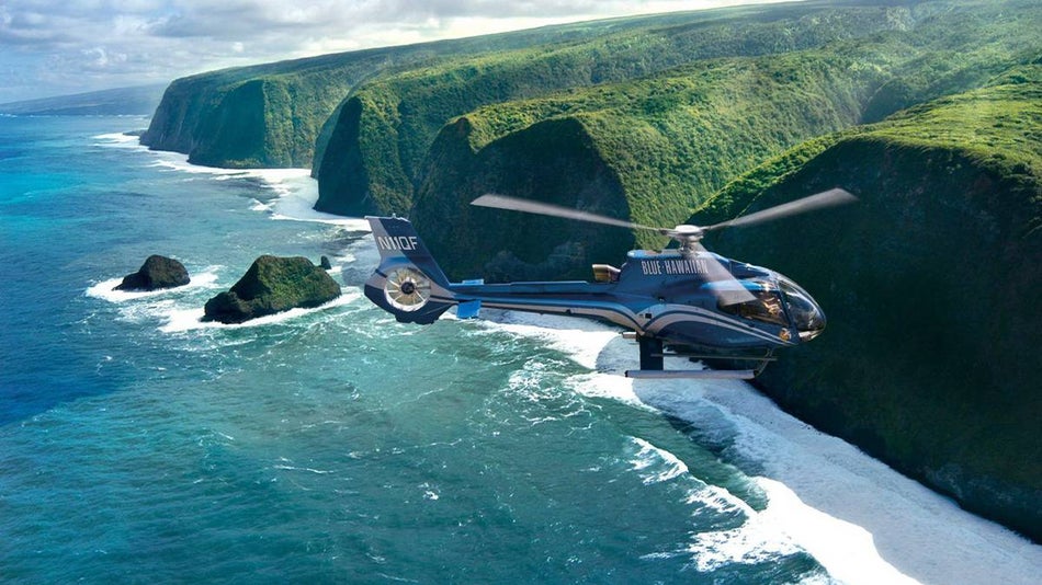 blue hawaiian helicopter flying over kohala for a tour