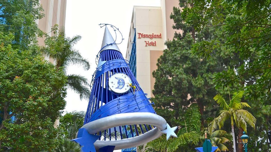 The blue Mikey magician hat with a Disneyland logo on it and the Disneyland Hotel in the background in Los Angeles, California, USA