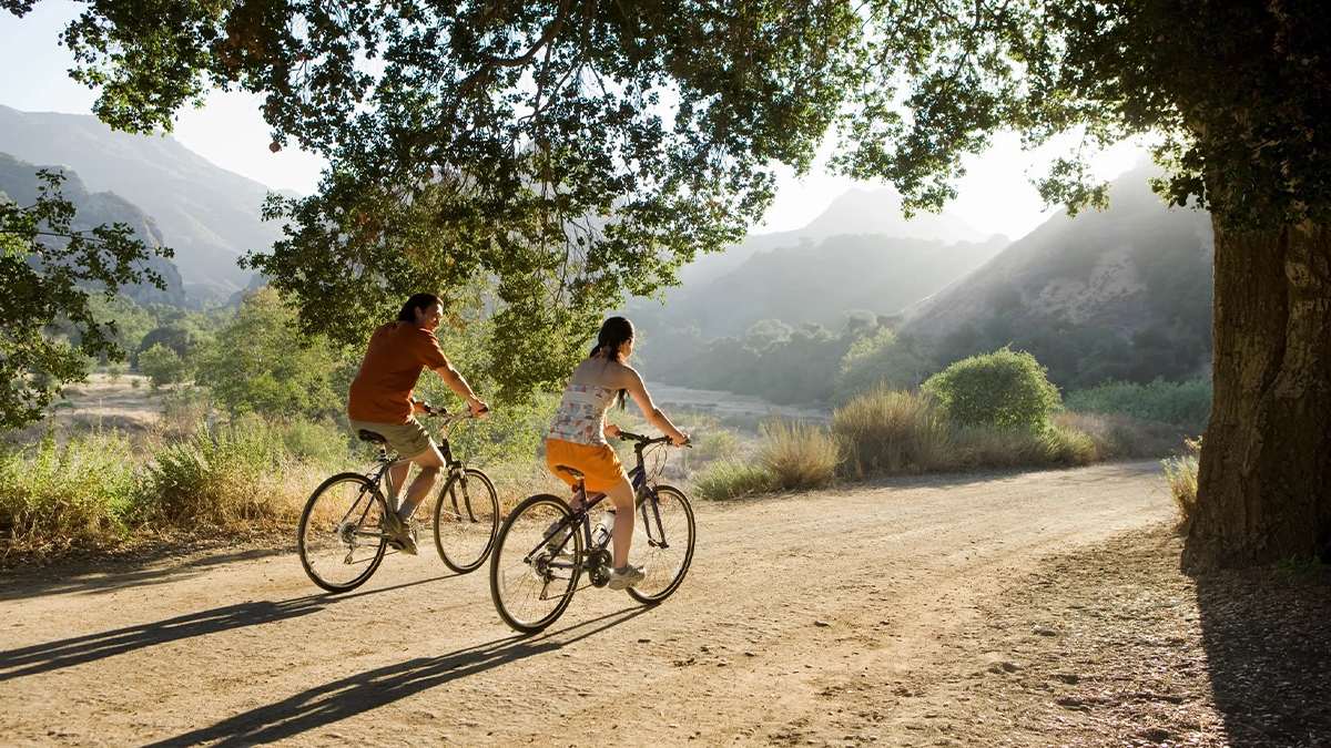 couples riding bikes together through the mountains near Los Angeles, California, USA