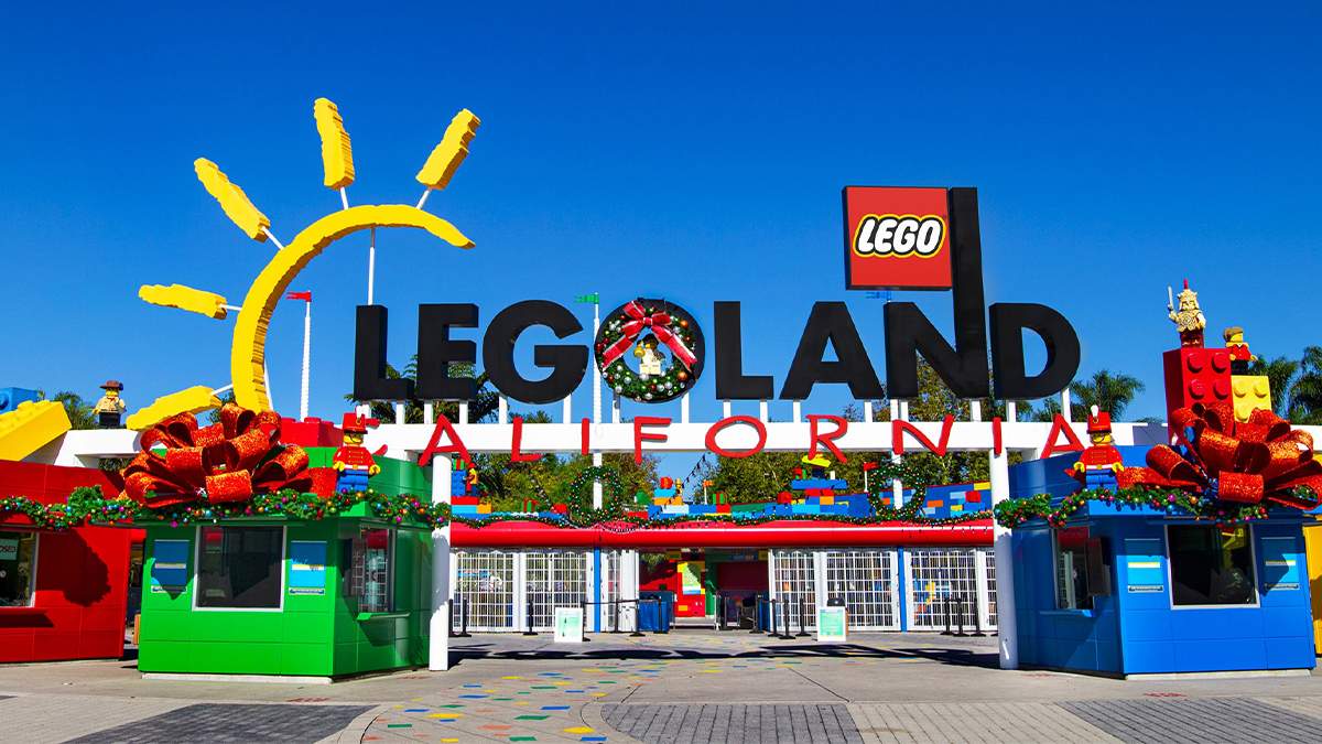 Front gate of LEGOLAND California when it is decorated for Christmas and a bright blue sky in the background in Los Angeles, California, USA