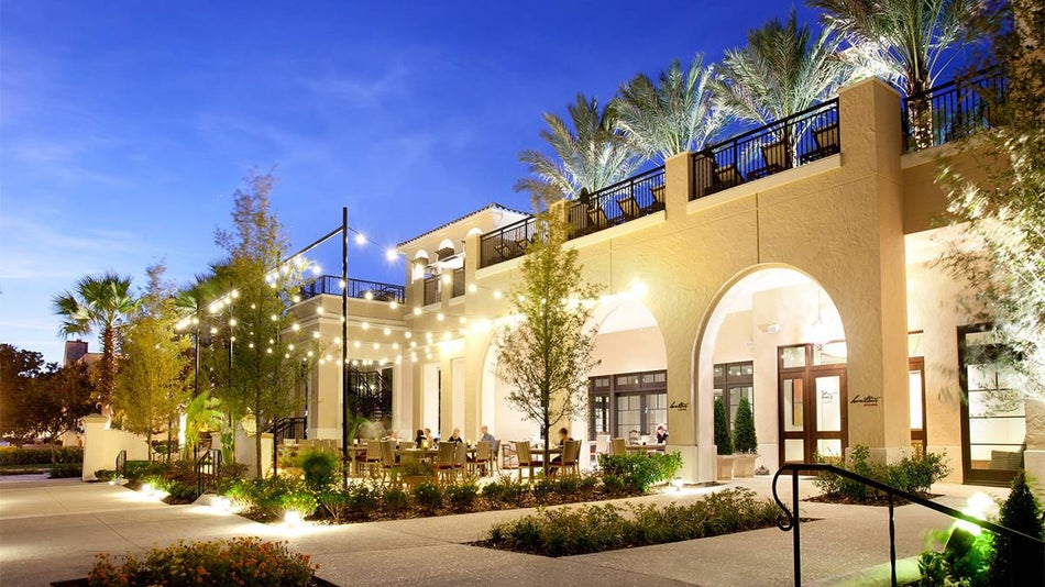 View of a restaurant at Alfond Inn with handing lights and green landscaping in Miami, Florida, USA