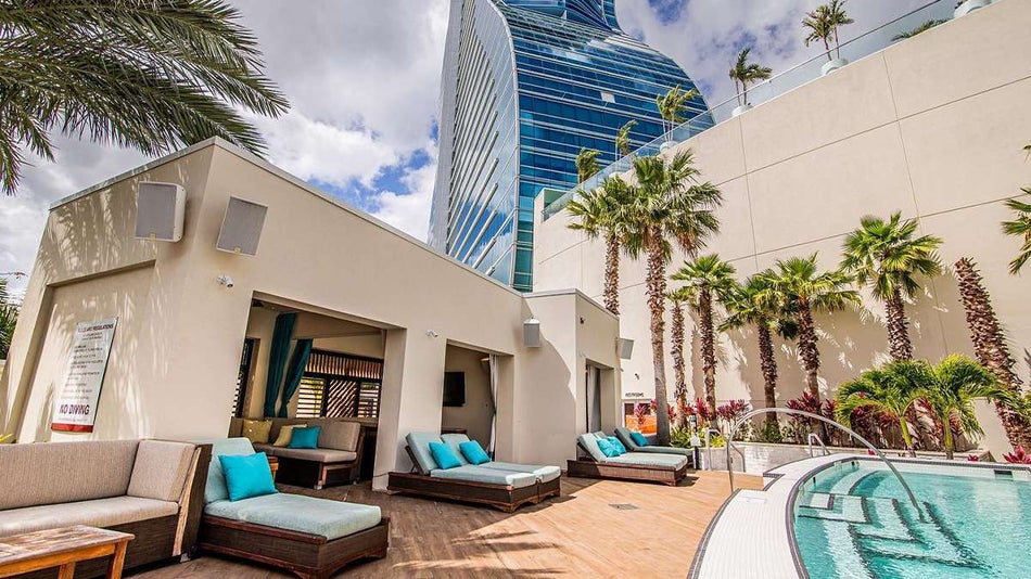 View of the lounge cabana and pool at DAER South Florida with a view of the giant guitar in the background in Miami, Florida, USA
