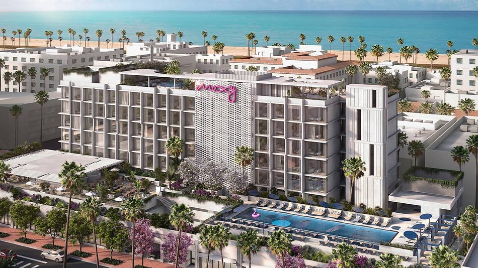 Aerial view of the Moxy South Beach with the ocean in background and palm trees lining the front in Miami, Florida, USA