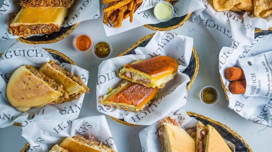 View of a table full of sandwiches and sides from Sanguich de Miami in Miami, Florida, USA