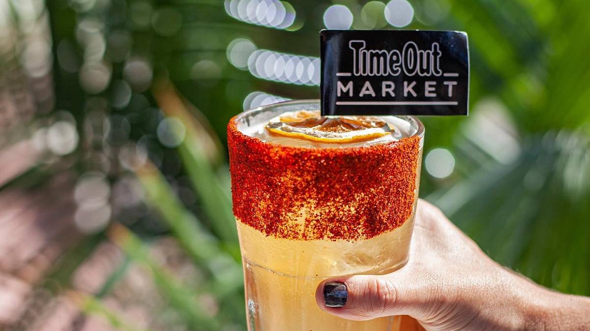 Close up of a cocktail with a flag in it that says Timeout Market in Miami, Florida, USA