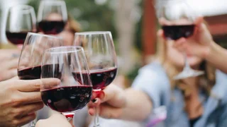 friends clinking wine glasses together at La Belle Amie Vineyards in Myrtle Beach, South Carolina, USA