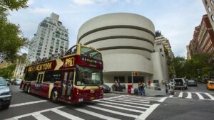 big bus tour bus driving through new york city