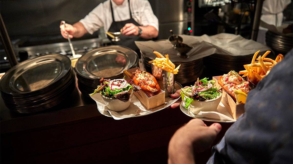 Close up photo of food coming out of the kitchen at Burger & Lobster in NYC, New York, USA