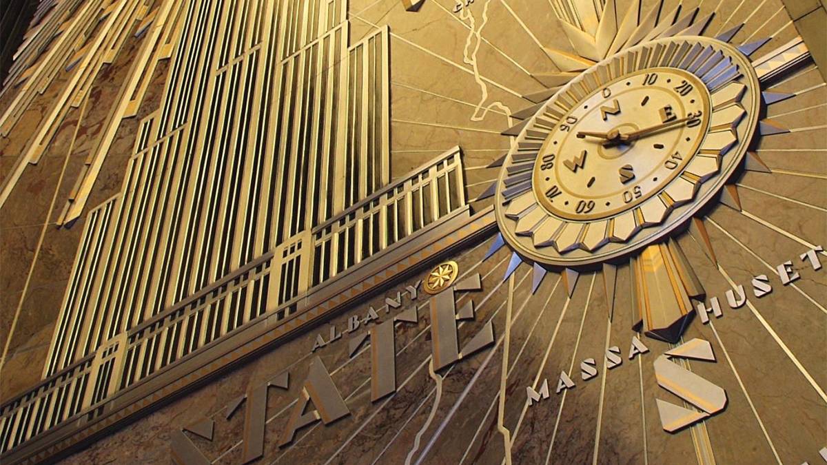 Close up of the gold Art Deco wall with a clock on in the 5th Avenue Lobby of the Empire State Building in NYC, New York, USA