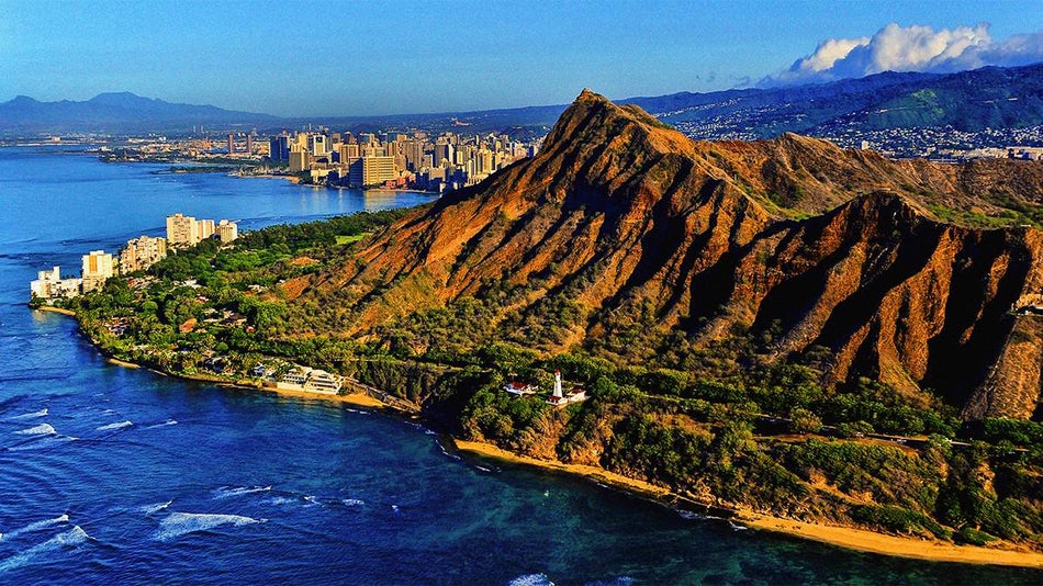 View looking at Diamond Head State Monument with the Pacific Ocean below on a sunny day in Oahu, Hawaii, USA